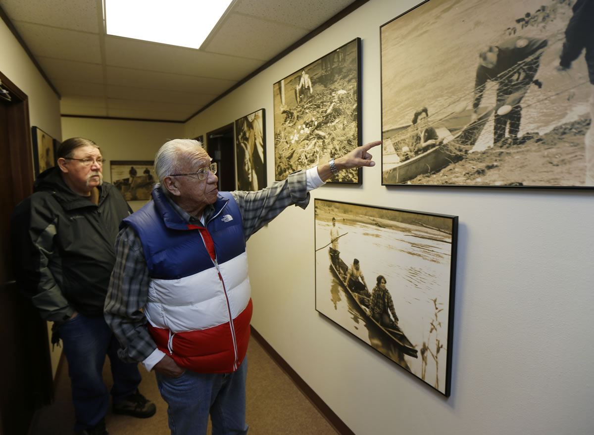 Billy Frank Jr., pointing, a Nisqually tribal elder who was arrested dozens of times while trying to assert his native fishing rights during the Fish Wars of the 1960s and '70s, looks at a photograph Monday in Olympia of his wife Norma being arrested for fishing.