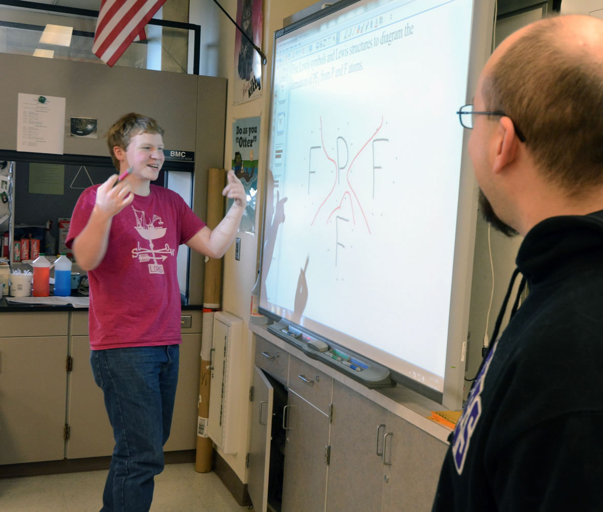 Anacortes High School senior Aidan Garcia explains his answer to teacher Cody Anderson during Anderson's AP Chemistry class Jan. 31 in Anacortes.