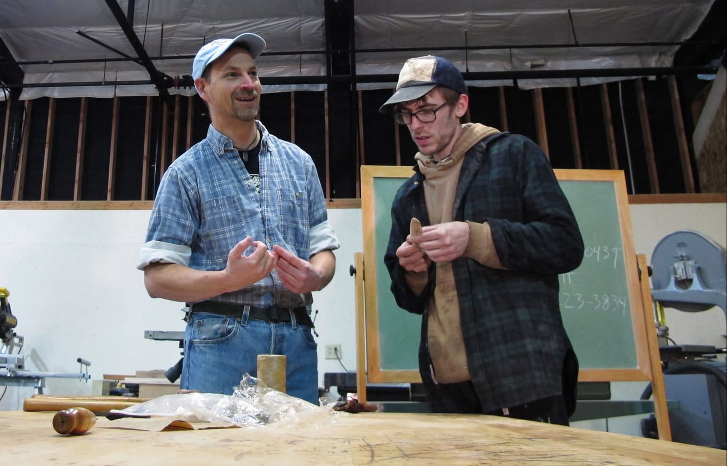 Instructor Tim Nagle, left, and student Clayton Norman discuss a knife Norman made in Nagle's Scandinavian knife-making class at Arbutus Folk School in Olympia on Nov.