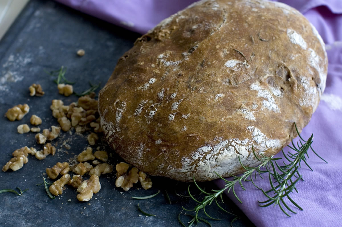 One of the ways to ensure your success with baking breads -- including this no-knead walnut-rosemary bread -- is by measuring your flour by weight, not volume.