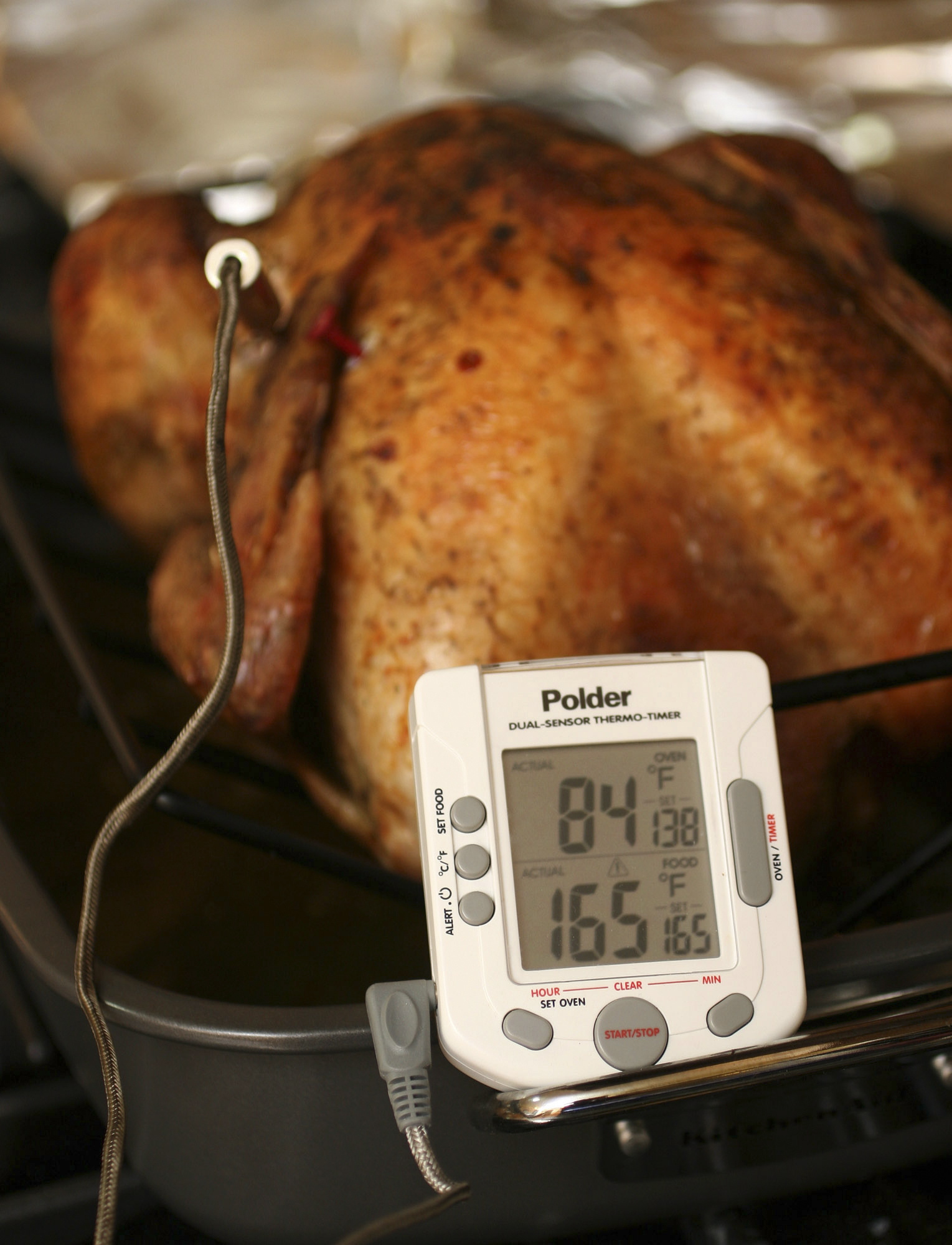 Use an instant thermometer inserted at the innermost part of the thigh (without touching bone) to determine when your turkey is done. The meat needs to hit 165 F for safe eating, though some people say thigh meat tastes better at 170 F.