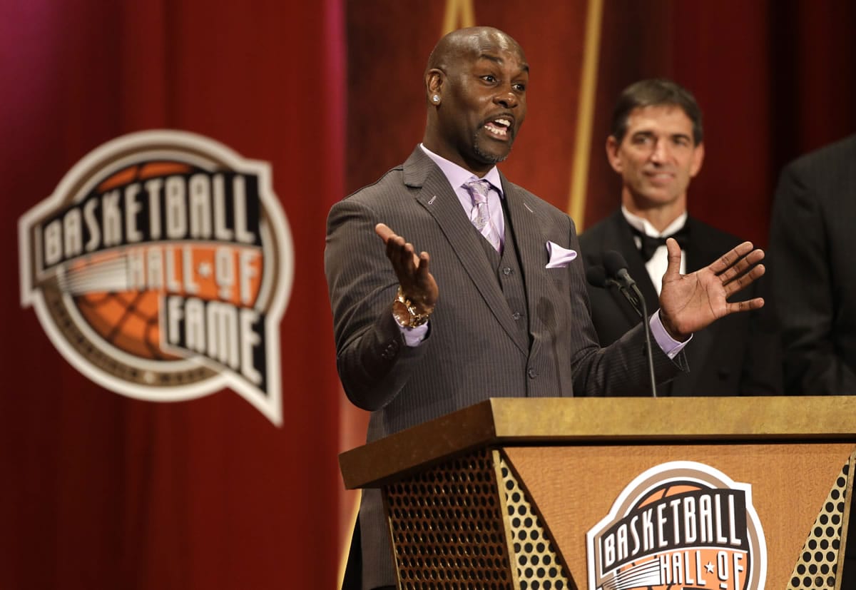 Inductee Gary Payton, left, speaks during the enshrinement ceremony for the 2013 class of the Naismith Memorial Basketball Hall of Fame as Hall of Famer John Stockton, right, looks on at Symphony Hall in Springfield, Mass., Sunday, Sept. 8, 2013.