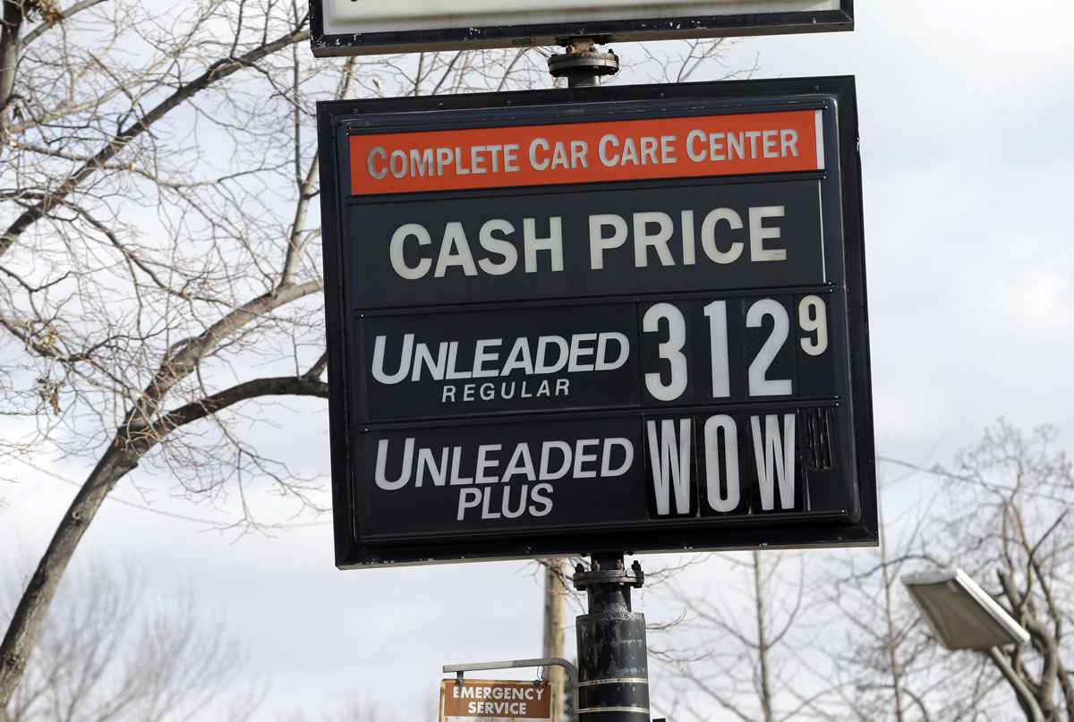 The cash price for unleaded fuel along with an editorial comment on unleaded-plus fuel was posted on a sign at a Minneapolis car-care center Tuesday in Minneapolis, as gas prices continue to fall just in time for Thanksgiving and holiday spending.