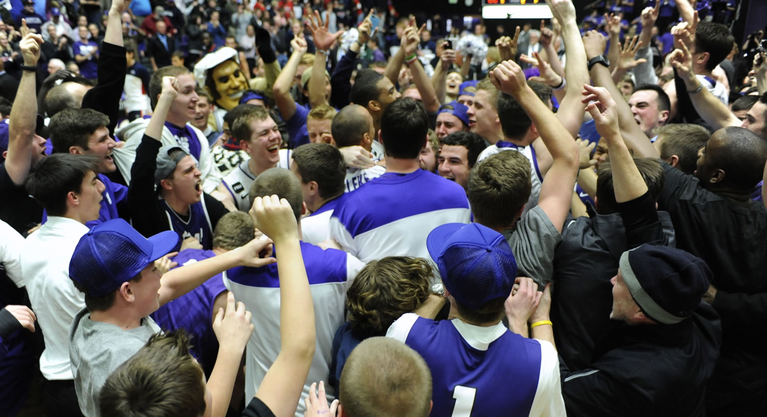 Players and fans celebrate at mid court after the Portland Pilots beat the Gonzaga Bulldogs 82-73 in a West Coast Conference game at the Chiles Center on Thursday.
