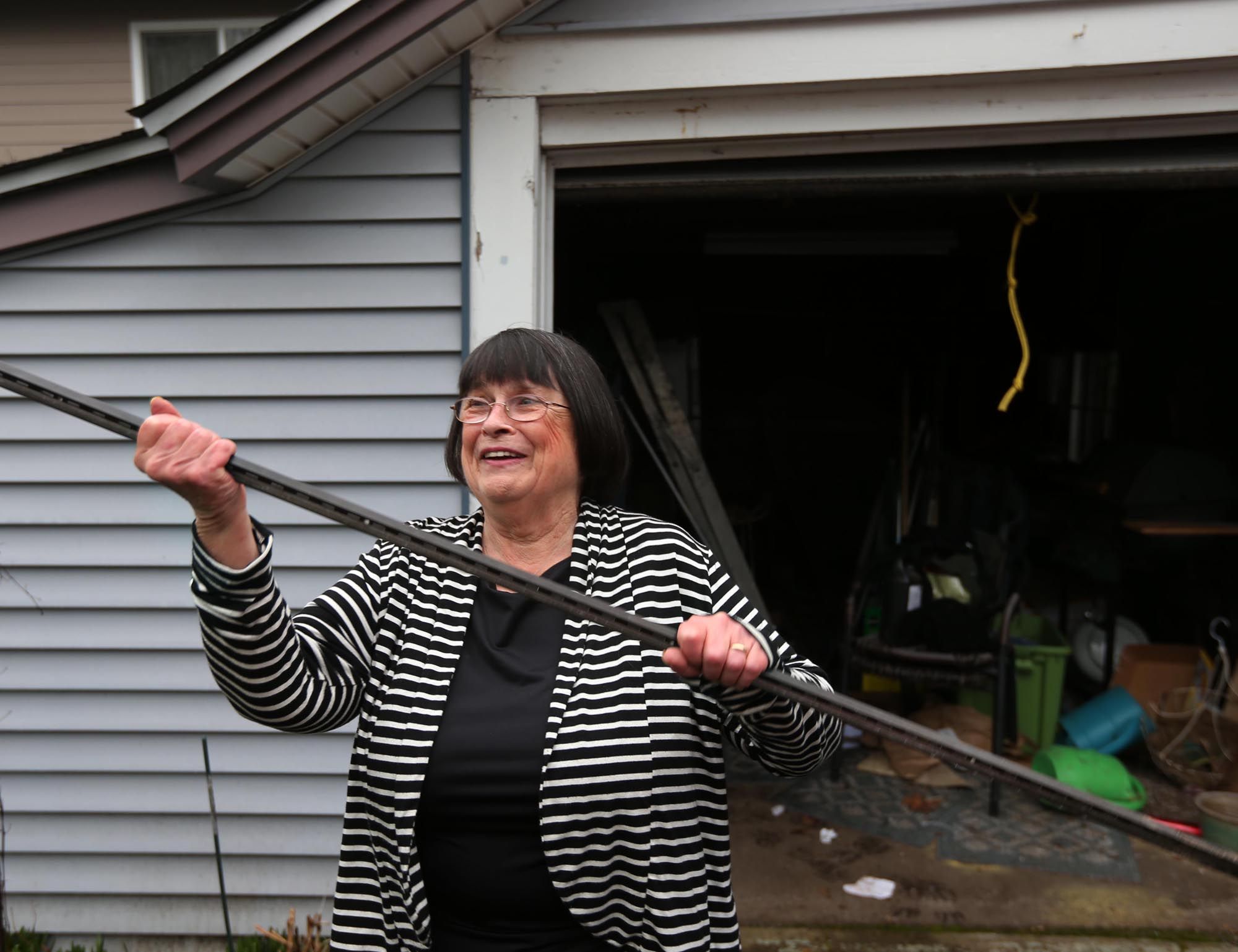 Janet &quot;Clubber&quot; Carlson, 72, on Thursday brandishes the piece of metal that she used to subdue a suspected burglar she recently discovered in her garage until police arrived, in Eugene, Ore.