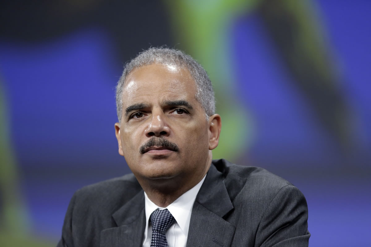 Attorney General Eric Holder listens to a speech after of his remarks during the Annual International Association of Chiefs of Police Conference, at the Pennsylvania Convention Center in Philadelphia.