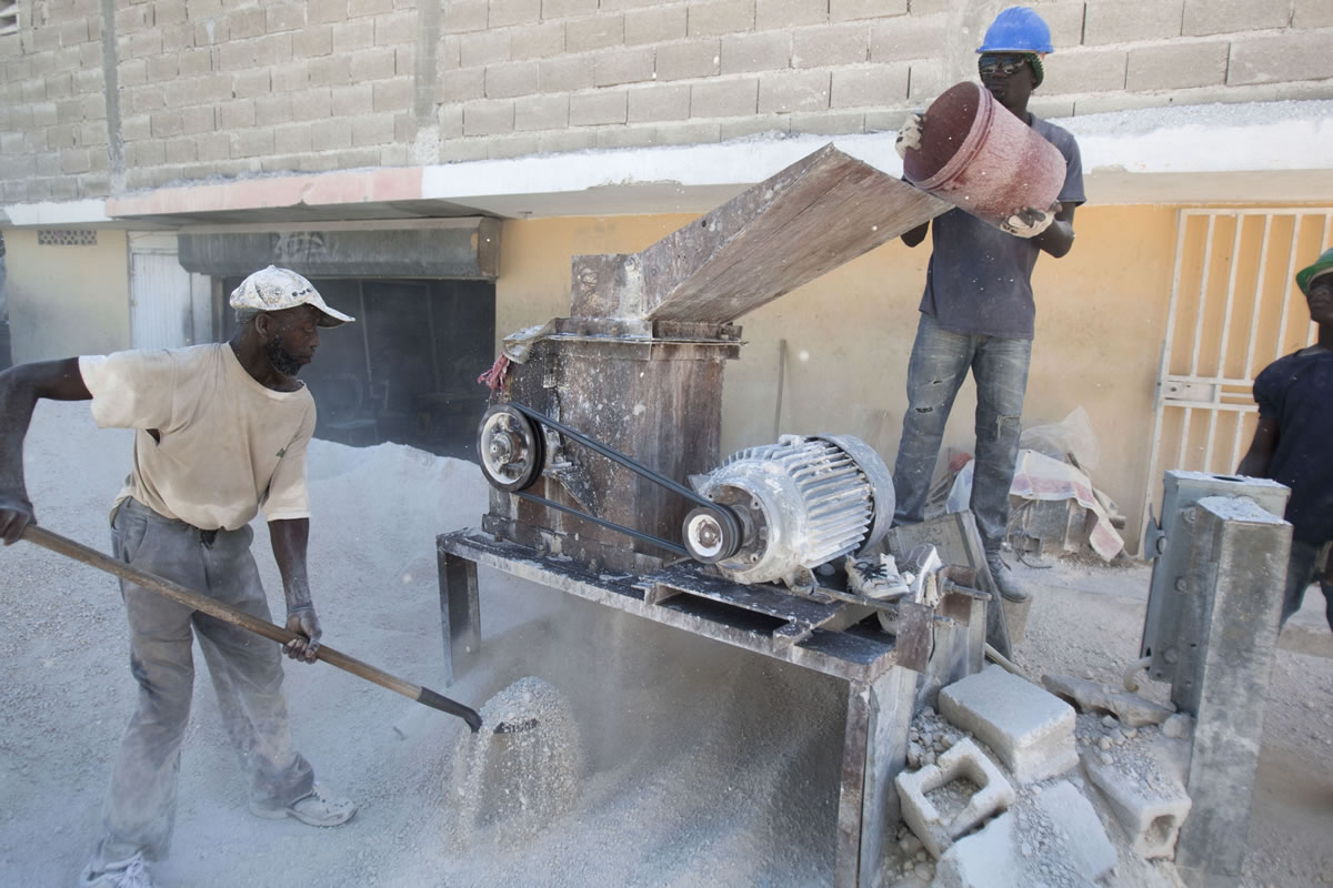 Workers make cinder blocks for construction in Port-au-Prince, Haiti, on Dec. 26.