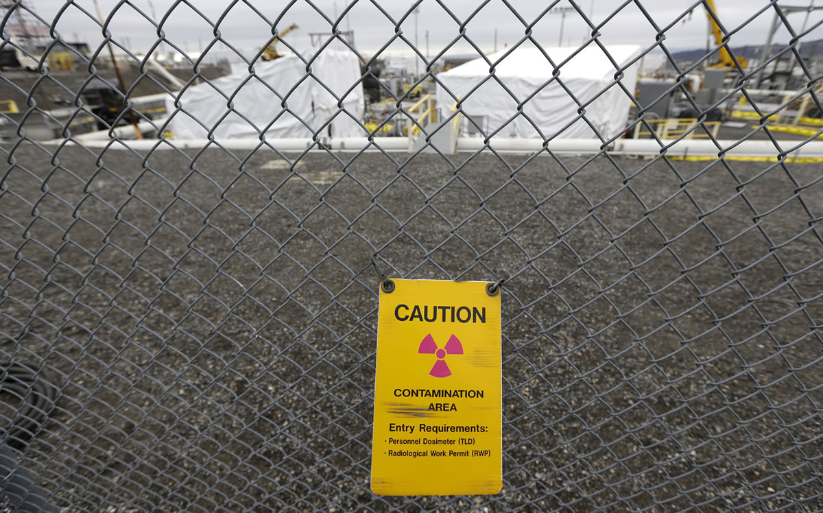 A warning sign is shown attached to a fence at the 'C' Tank Farm at the Hanford Nuclear Reservation near Richland.