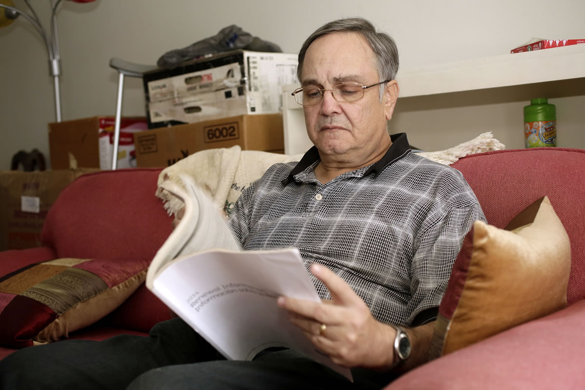 Howard Kraft looks over health care information in his Lincolnton, N.C., home Monday.