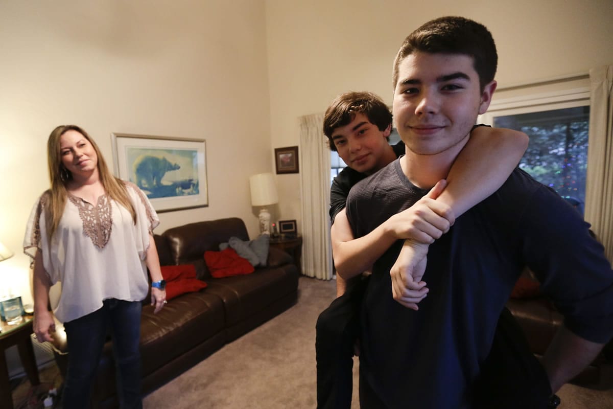 From left, Deanna Kremis and her sons, Trevin Kremis and Matthew Kremis, all have received heart transplants because of an inherited heart condition.
