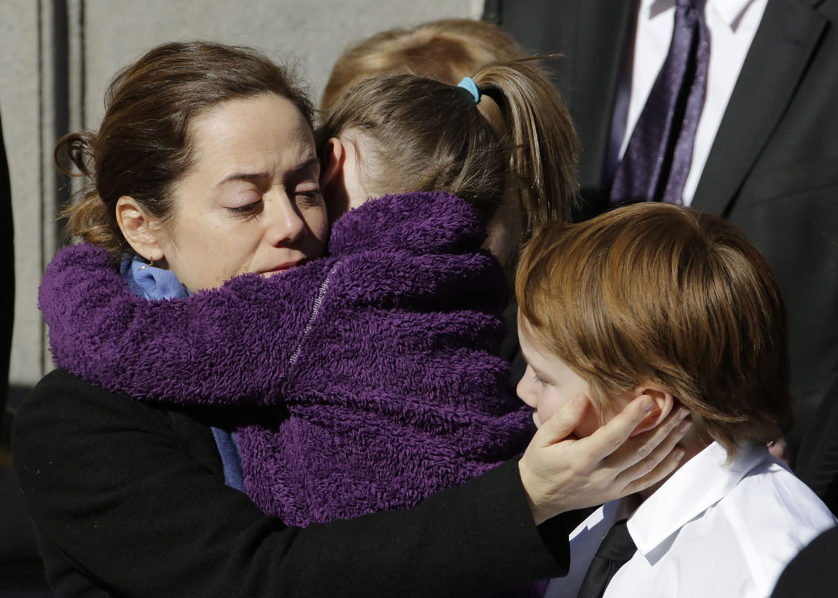 Mimi O'Donnell, estranged partner of actor Philip Seymour Hoffman, comforts two of their children, daughter Willa and son Cooper, as his casket arrives at the Church of St. Ignatius Loyola on, Friday in New York.