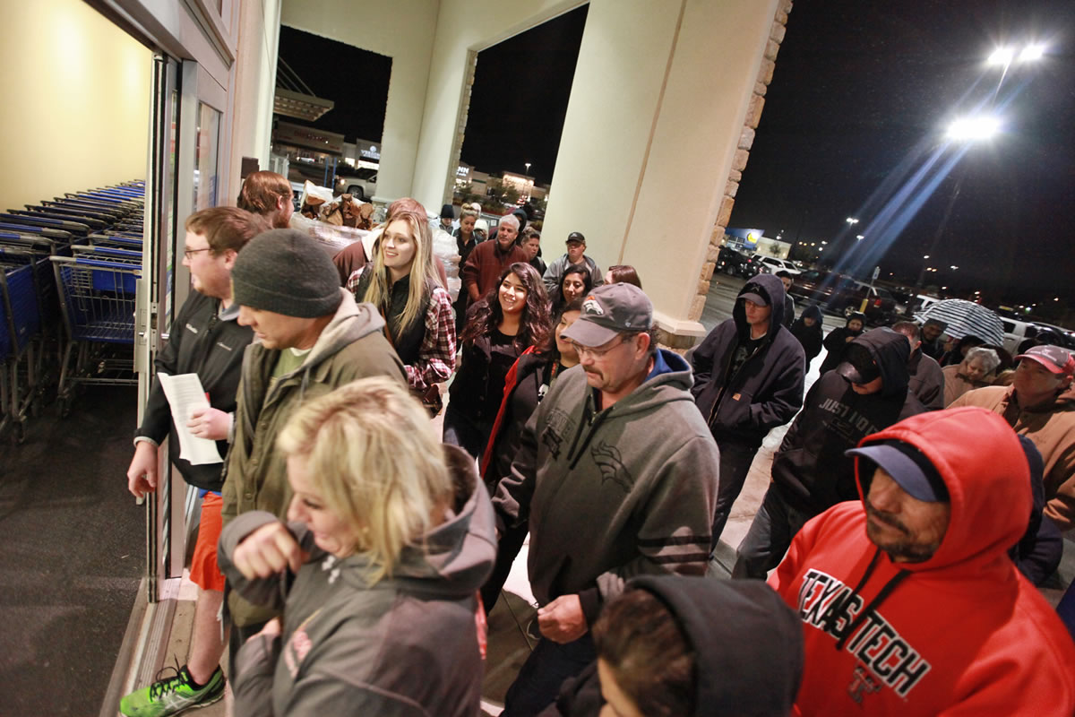 Shoppers rush through the entrance to the Academy Sports+Outdoors at 5:00 a.m. in the Chimney Rock Shopping Center on Friday, Nov. 27, 2015, in Odessa, Texas. Early numbers arent out yet on how many shoppers headed to stores on Thanksgiving, but its expected that more than three times the number of people will venture out to shop on the day after the holiday known as Black Friday.