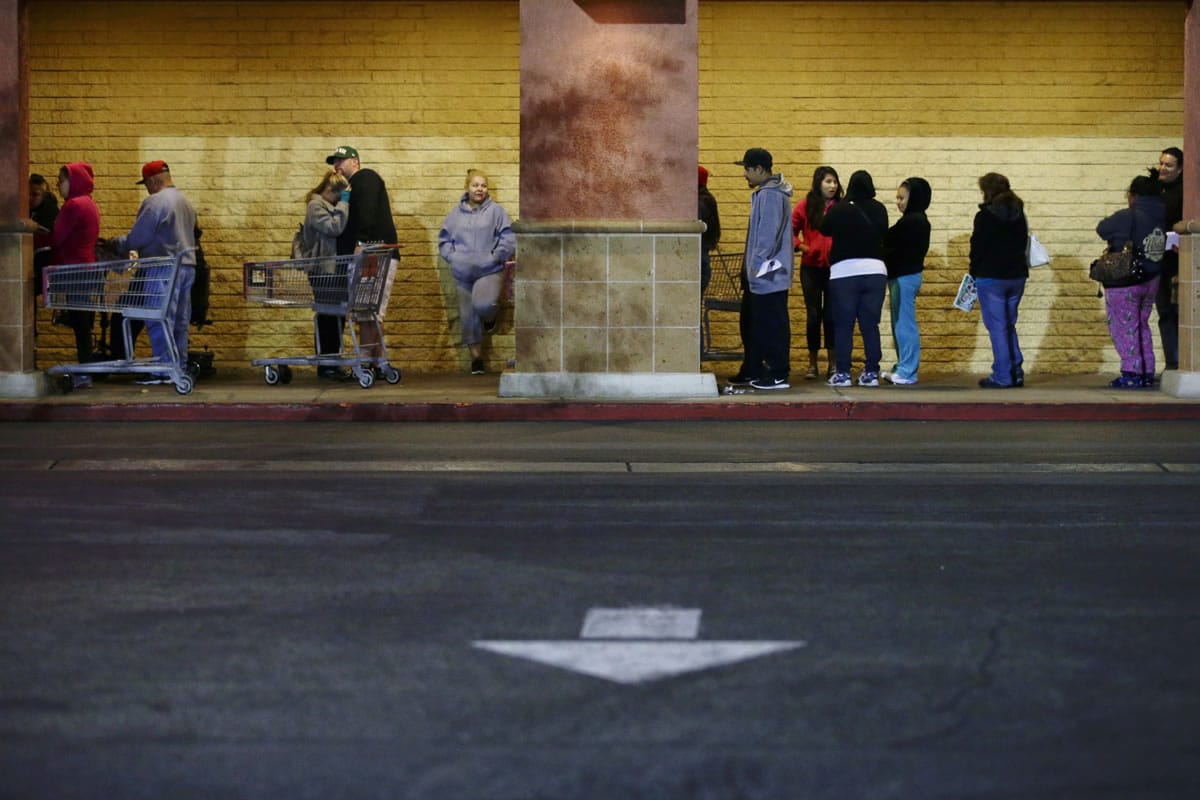 Shoppers wait outside a Kmart store for it to open Thursday in Anaheim, Calif.