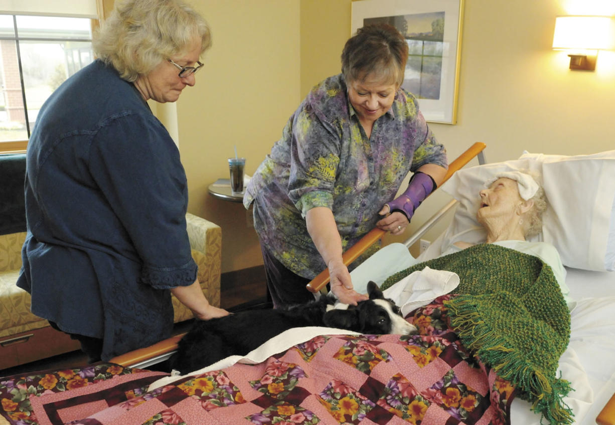 Nurse Jody Buktenica, left, with her therapy dog Phoebe, a Cardigon Welsh Corgi, visit Judi Forbess of Albany, Ore. and her mother Lillian Downs on Jan. 10 at Samaritan Evergreen Hospice House in Albany.