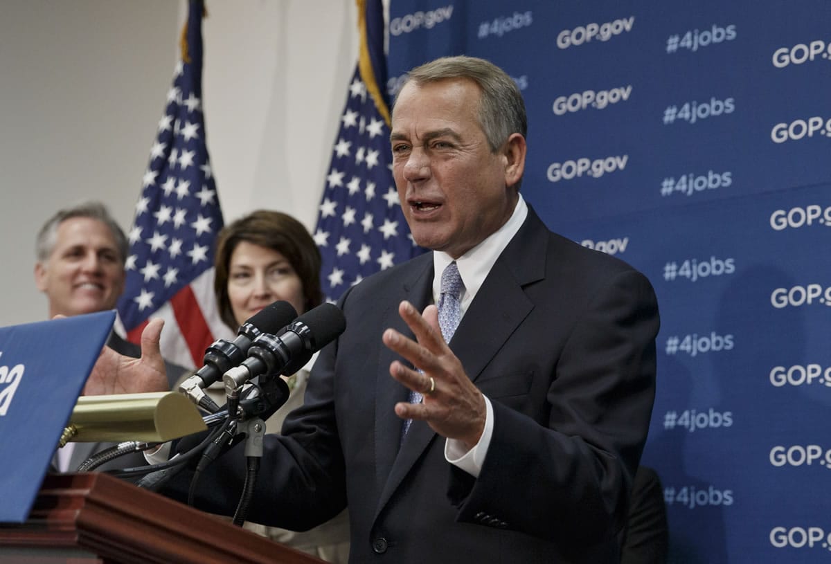 House Speaker John Boehner of Ohio, right, accompanied by House Majority Whip Kevin McCarthy of Calif., left, and Rep.