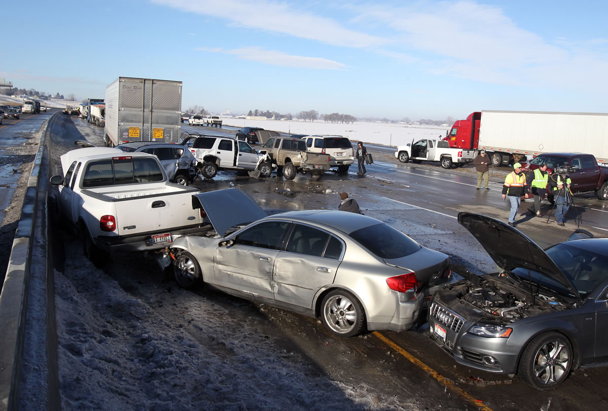Vehicles are damaged after a pileup involving a logging truck and more than 40 other vehicles Thursday on Interstate 84 in Meridian, Idaho.