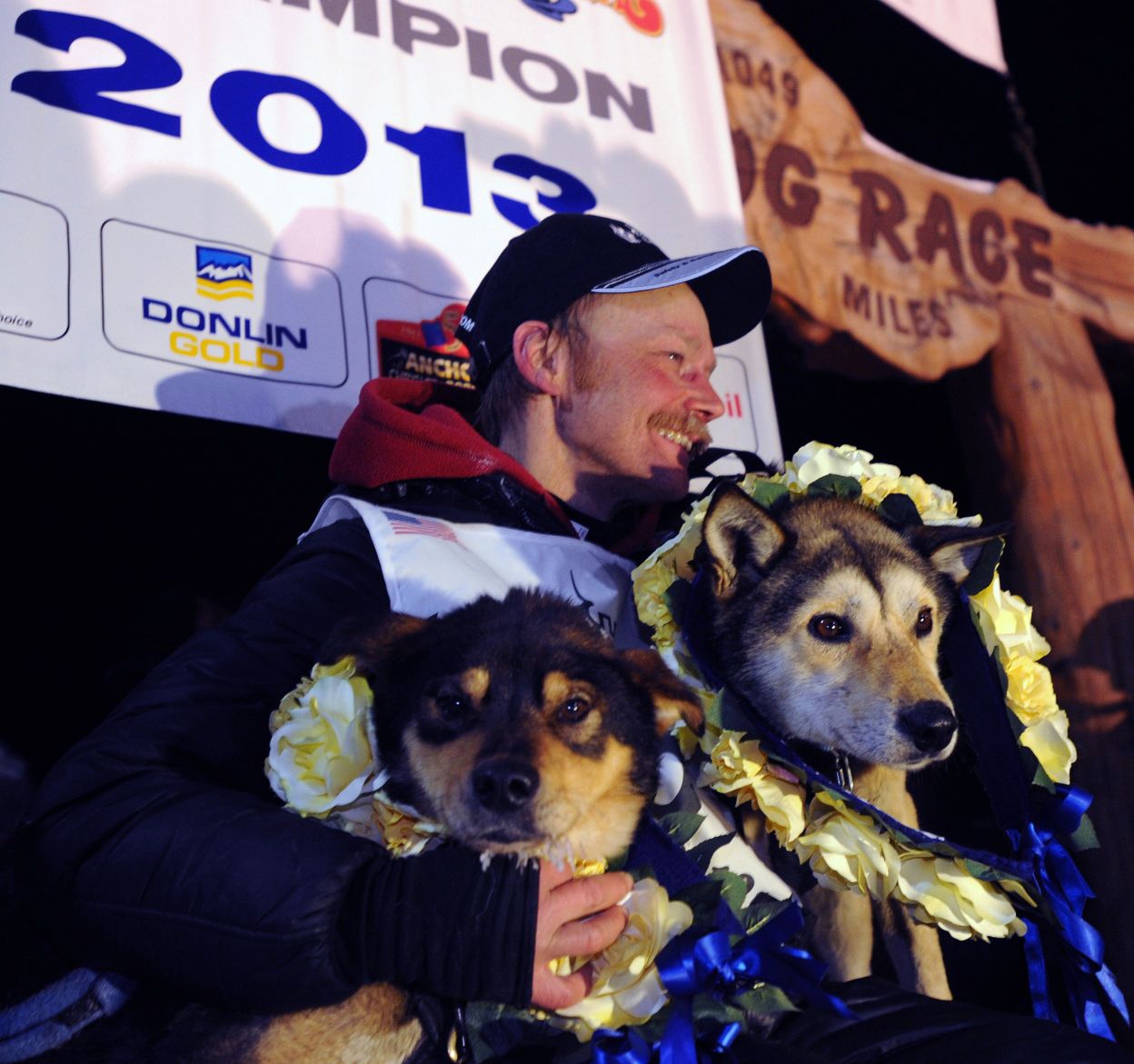 Mitch Seavey holds his lead dogs, Tanner, left, and Taurus as he poses at the finish line of the Iditarod Trail Sled Dog race in Nome, Alaska, on March 12, 2013.