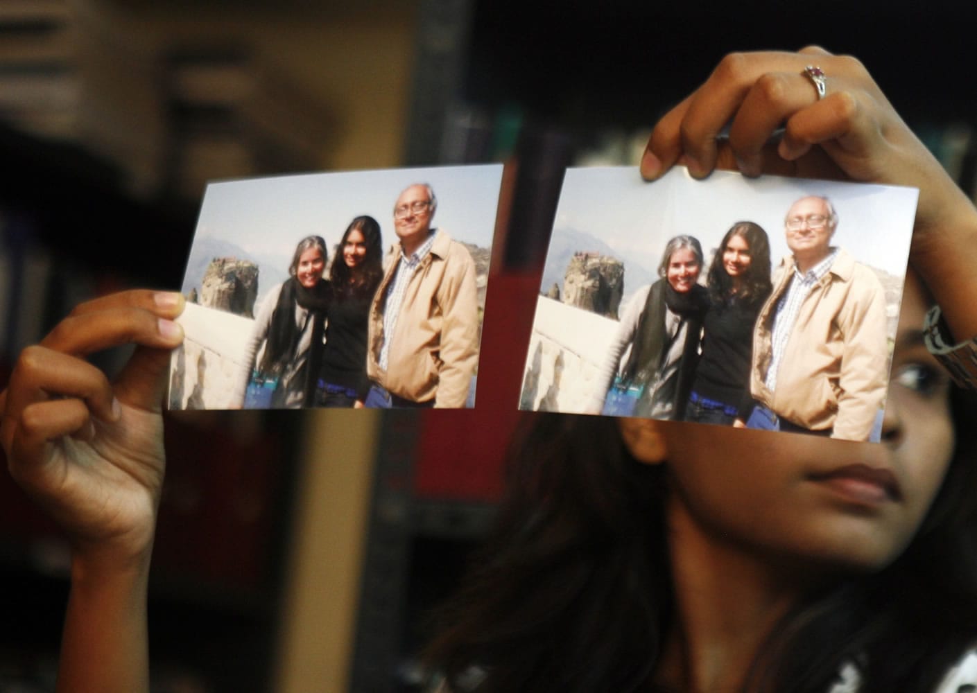 Photographs showing one of the passengers of the missing Malaysian Airlines aircraft Chandrika Sharma, left, her husband Narendran and daughter Meghna, are displayed during a press conference in Chennai, India, on Wednesday.