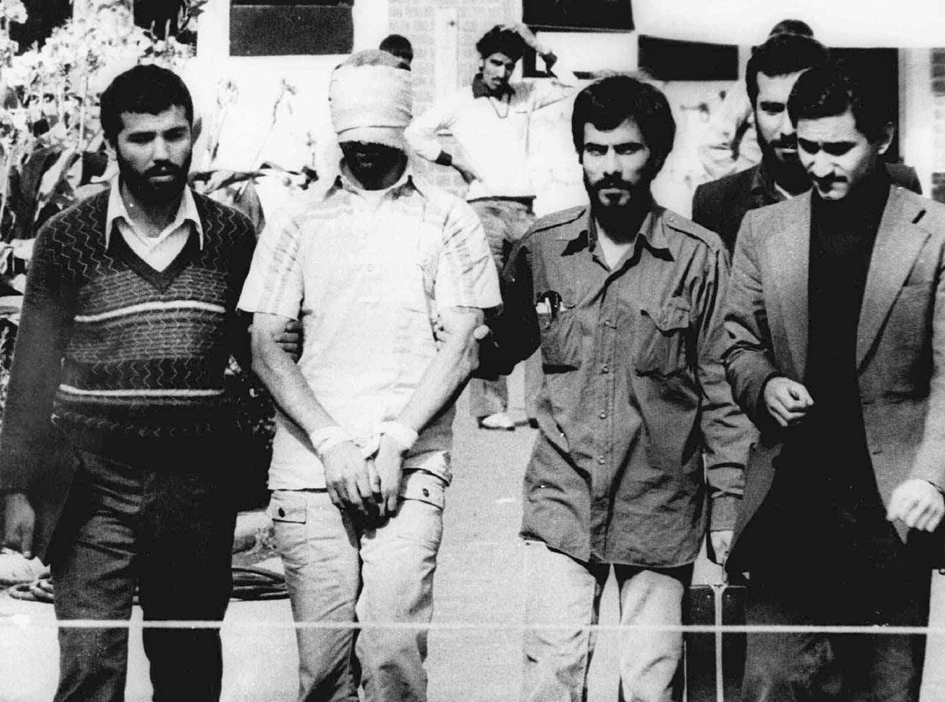 One of the hostages being held at the U.S. Embassy in Tehran is displayed to the crowd, blindfolded and with his hands bound, outside the embassy Nov. 9, 1979.