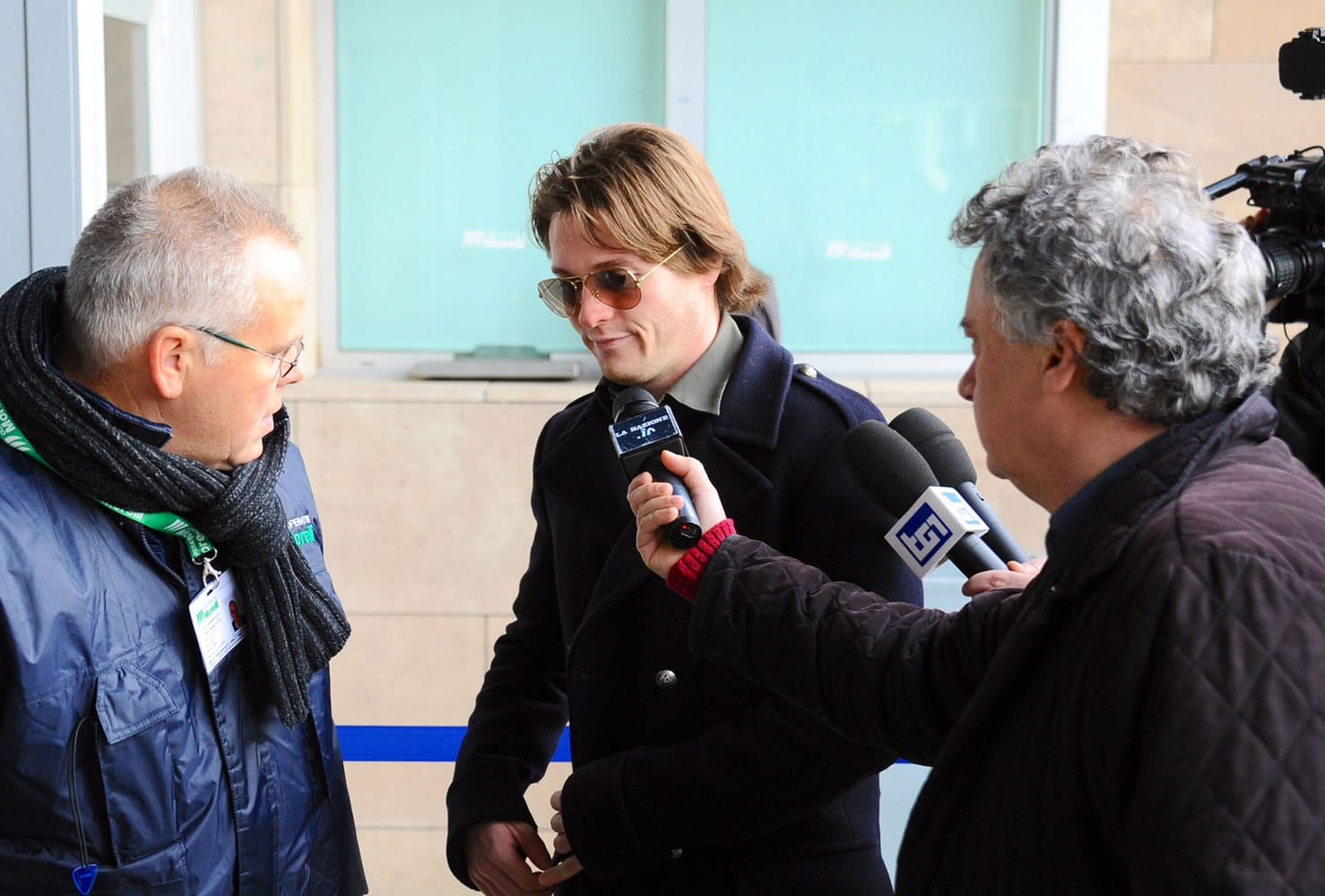 Raffaele Sollecito, center, is chased by reporters outside the Florence court, Italy, in early January.
