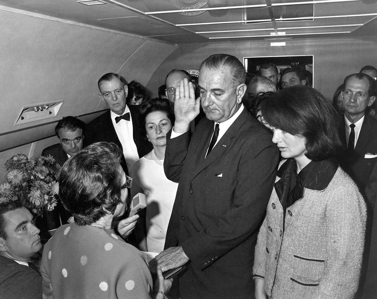 Lyndon B. Johnson is sworn in as president on Nov. 22, 1963, in the cabin of the presidential plane at Love Field in Dallas. Jacqueline Kennedy stands at right; Judge Sarah T.