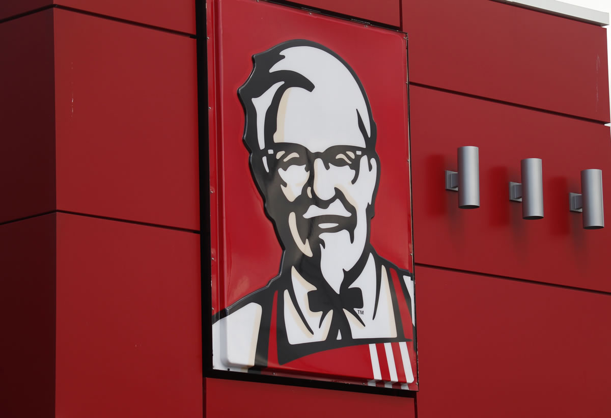 A close-up of a sign with a picture of Colonel Sanders is shown on the wall of a combination Kentucky Fried Chicken and Taco Bell in Doral, Fla.
