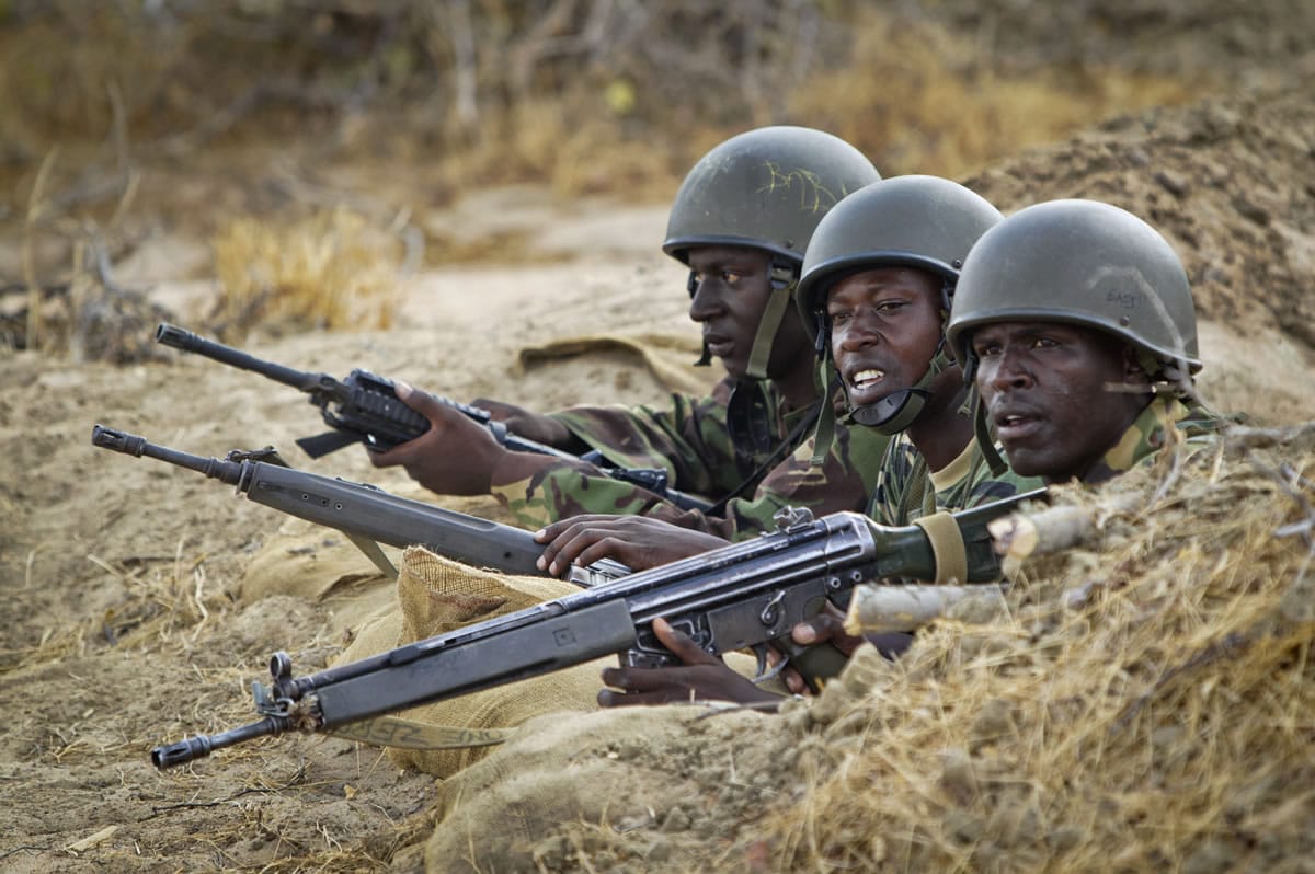 Kenyan army soldiers stand in a dugout position at their base in Tabda, inside Somalia, in February 2012.