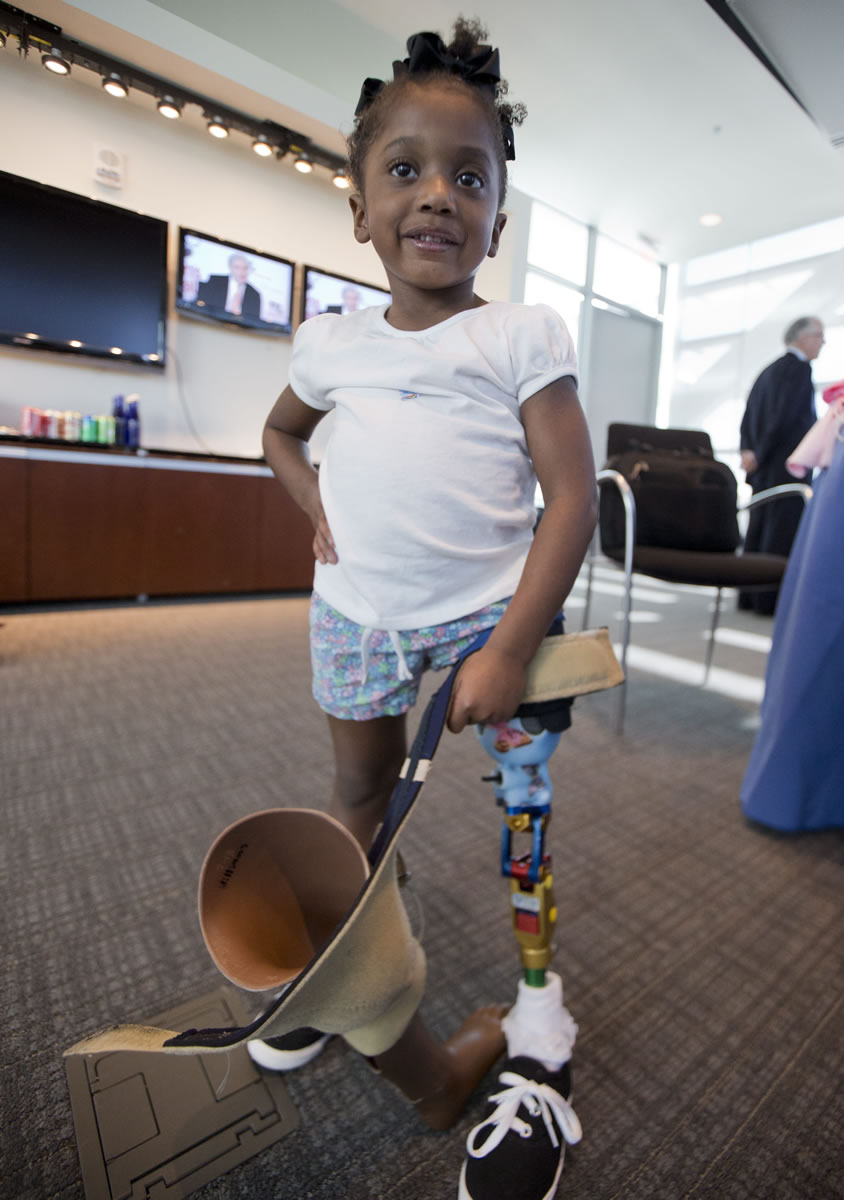 Miyah Williams, 3, holds her old prosthetic leg while showing off a new one in Washington during a meeting on the need for innovative pediatric medical devices.