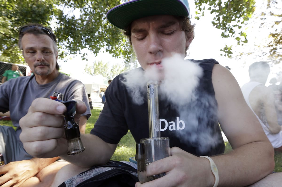 Cody Park exhales a cloud of marijuana smoke after taking a hit on a bong at the first day of Hempfest in Seattle in August. A new study by the Rand Corp.