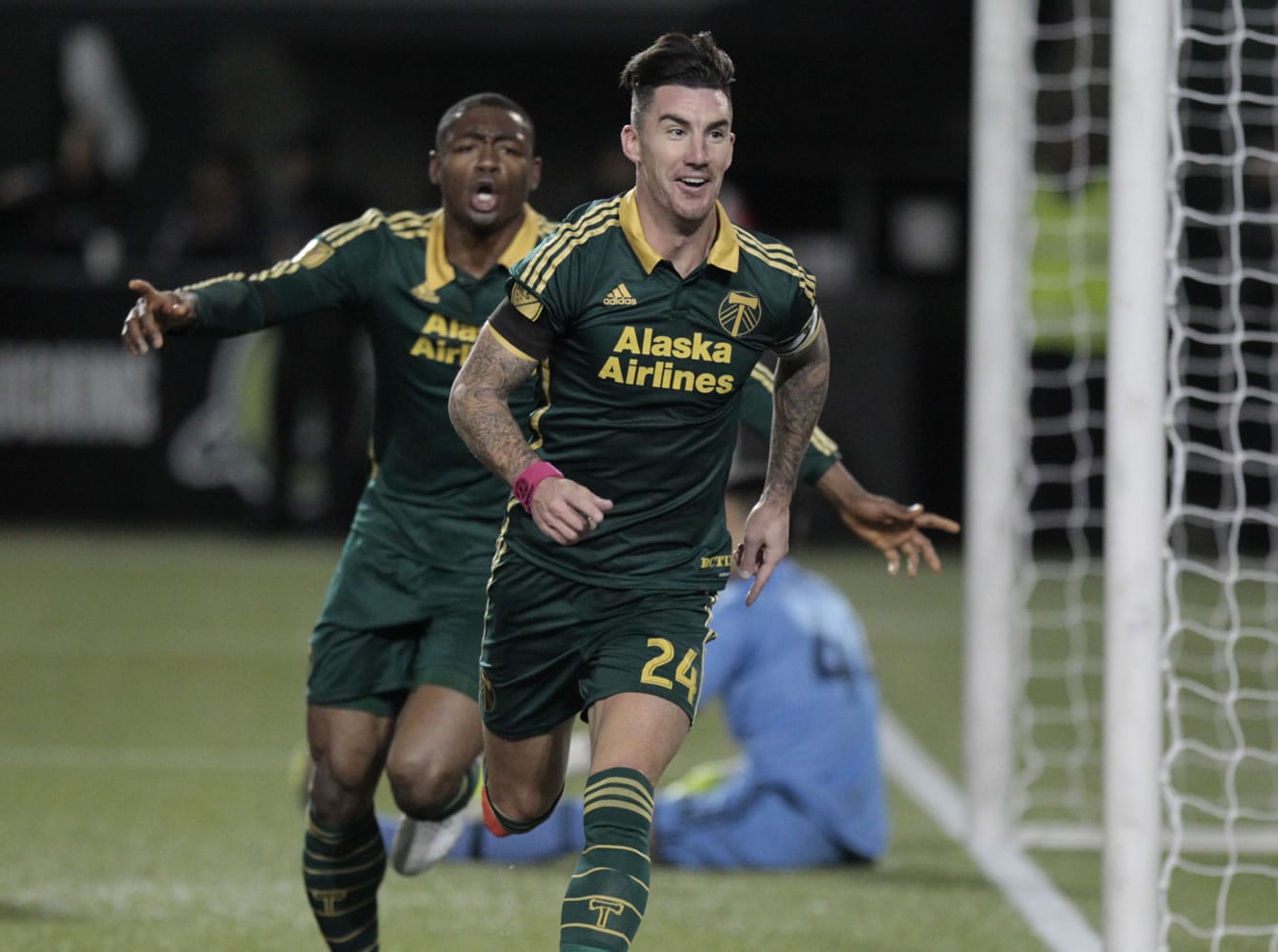 Portland Timbers forward Fanendo Adi (9) and defender Liam Ridgewell (24) celebrate Ridgewell's goal during the first half of the first leg of the MLS soccer Western Conference championship in Portland, Ore., Sunday, Nov. 22, 2015.