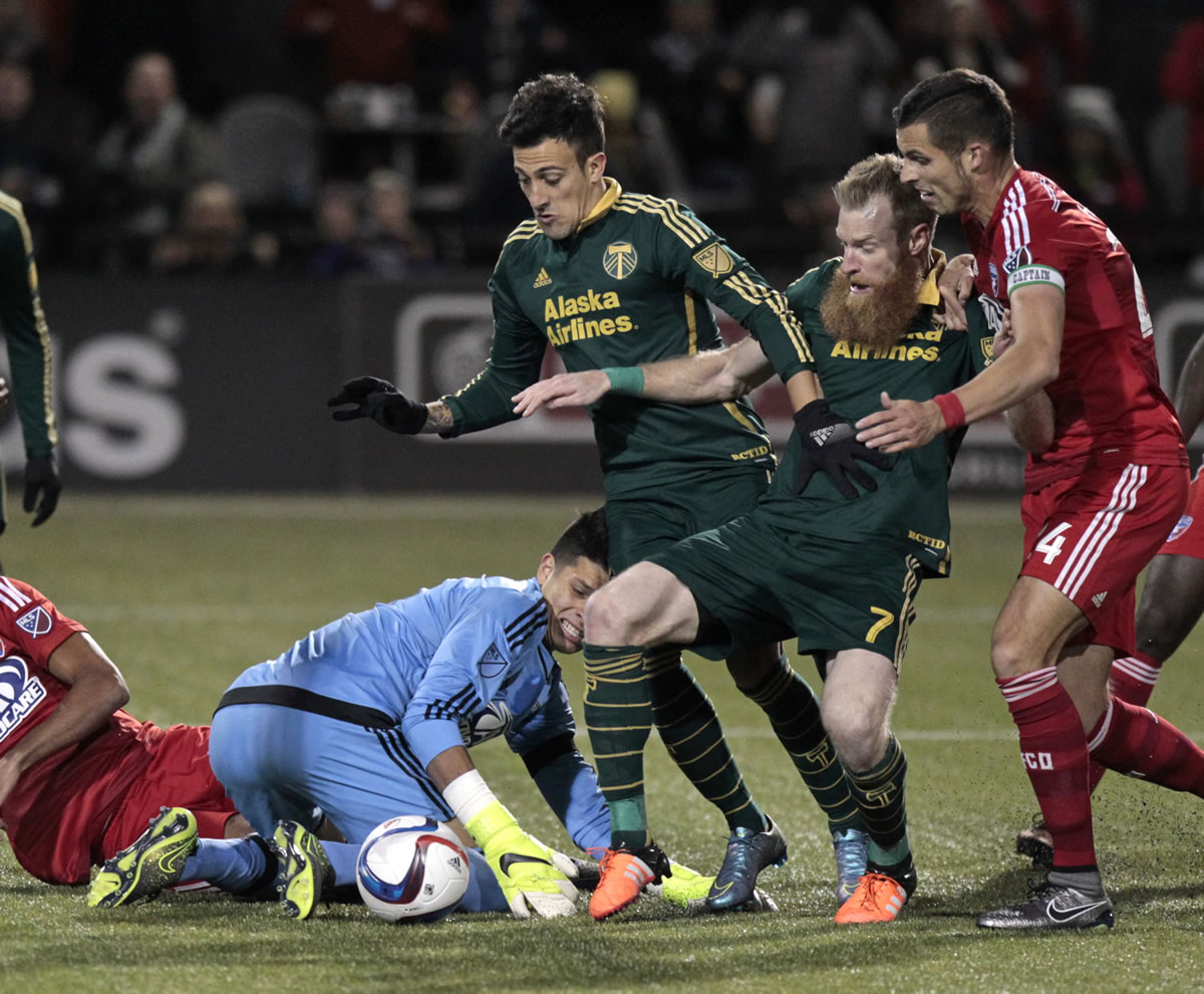 Portland Timbers defender Nat Borchers (7) shoots and scores next to Portland Timbers midfielder Maximiliano Urruti (37), against FC Dallas goalkeeper Jesse Gonzalez (44) and defender Matt Hedges (24) during the second half of the first leg of the MLS soccer Western Conference championship in Portland, Ore., Sunday, Nov. 22, 2015.