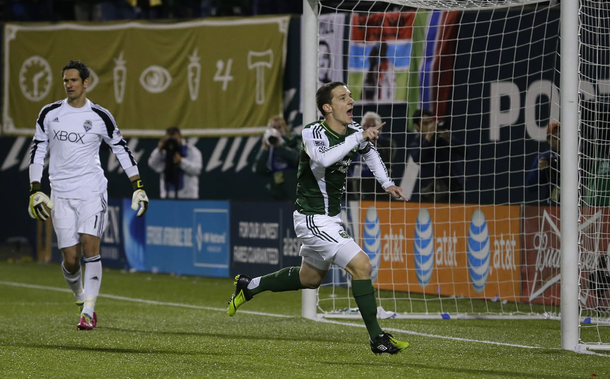 Portland Timbers' Will Johnson, right, celebrates after he scored a goal on Seattle Sounders goalkeeper Michael Gspurning, left, on a penalty kick in the first half of the second game of the Western Conference semifinals in the MLS Cup soccer playoffs, Thursday, Nov. 7, 2013, in Portland, Ore. (AP Photo/Ted S.