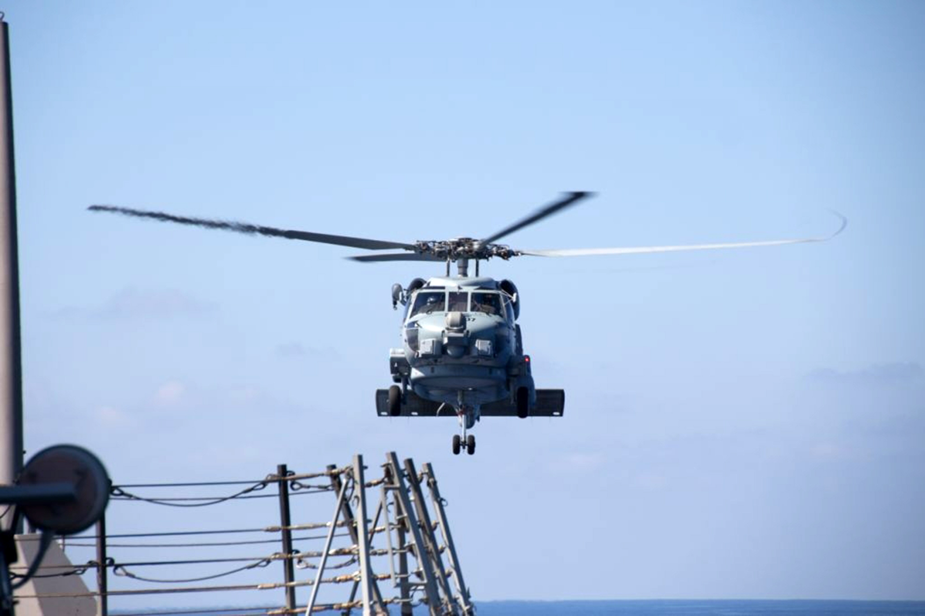 A U.S. Navy helicopter departs from the USS Pinckney to aid in the search and rescue efforts for missing Malaysian airlines flight MH370 in the Gulf of Thailand on Sunday.