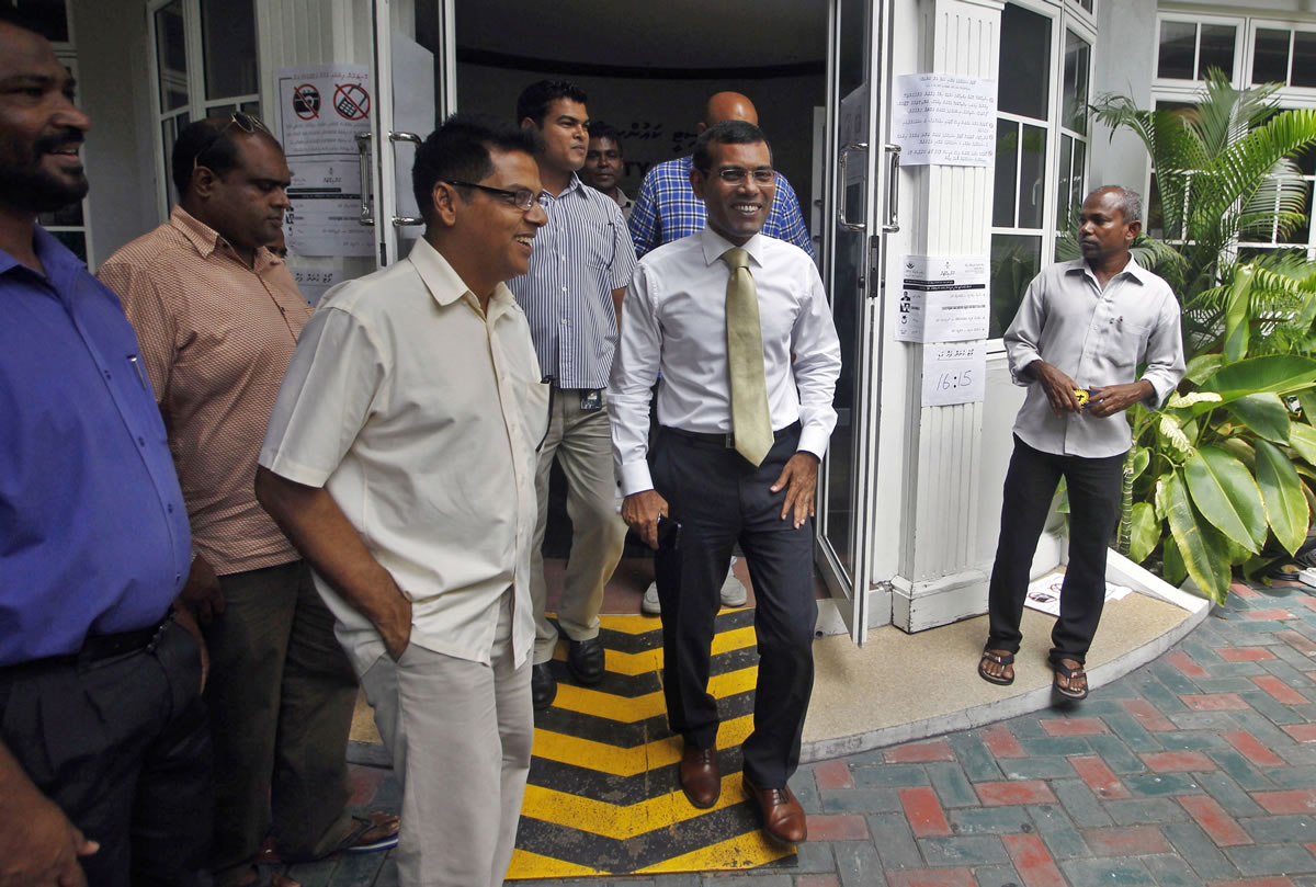 Former Maldives president and presidential candidate, Mohamed Nasheed, center, leaves after speaking to the media Sunday in Male, Maldives. Nasheed received 47 percent of the vote a day earlier.