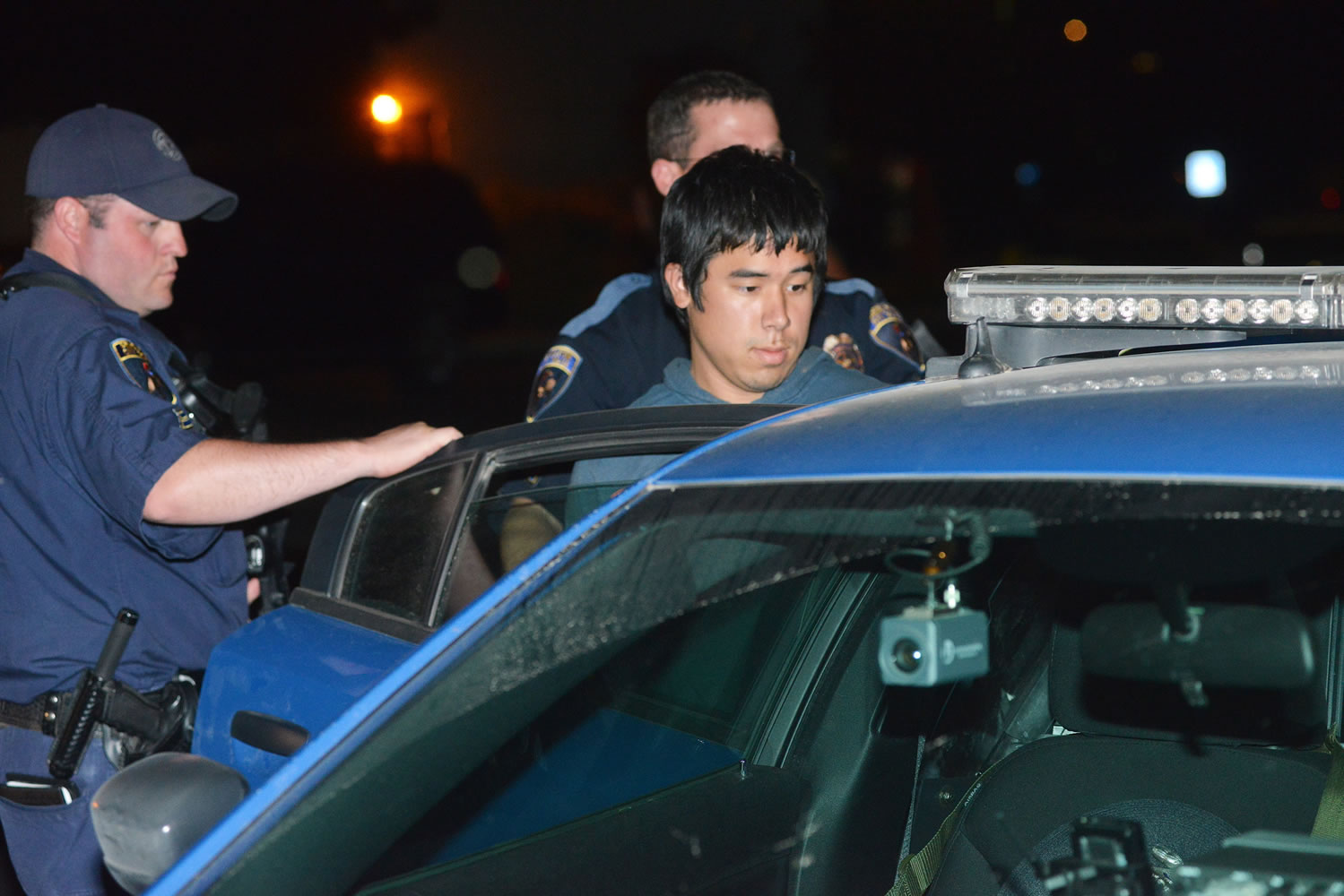 Lukah Pobzeb Chang is put into a patrol car by Pendleton Police on Aug. 28, 2013.
