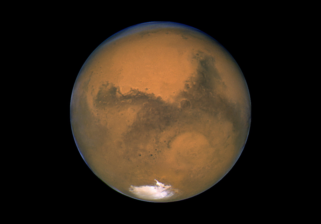 This Aug. 26, 2003, image made available by NASA shows Mars photographed by the Hubble Space Telescope on the planet's closest approach to Earth in 60,000 years. In the next four years, Mars One wants to get the applicant group of those who want a one-way ticket to the red planet down to about 40. Those selected will train in groups for seven years.