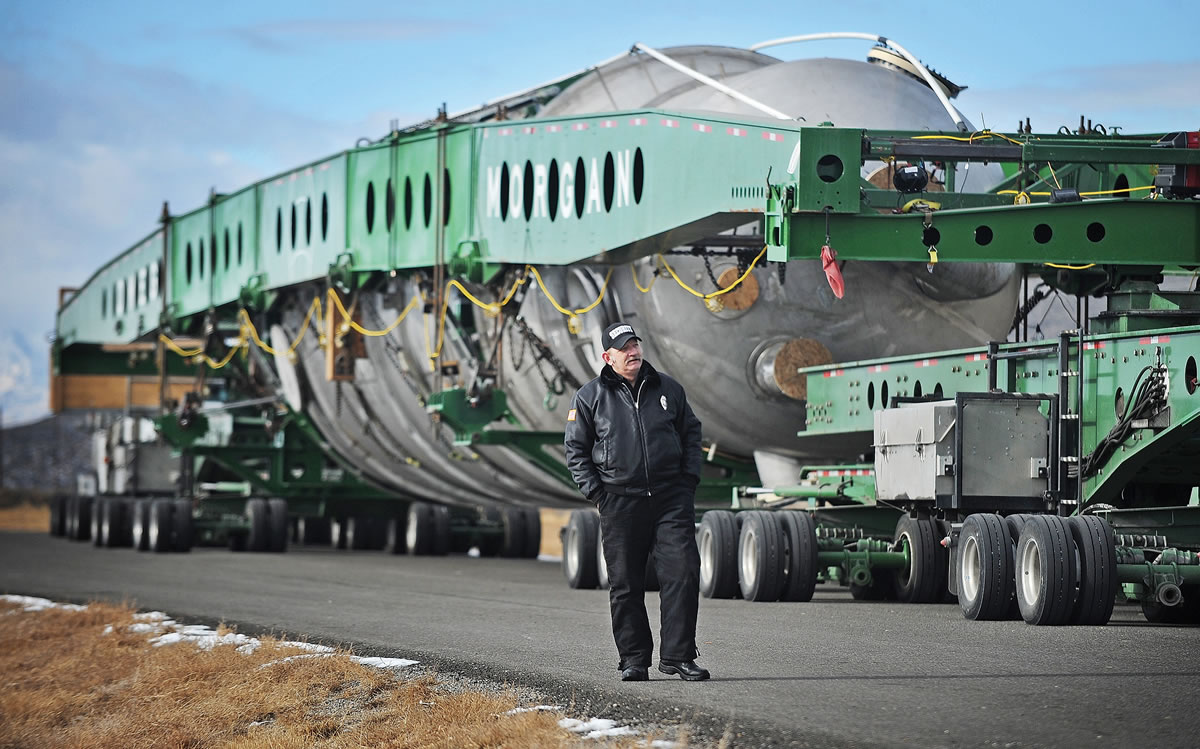 Pat Sutphin/The Idaho Post-Register
A security officer walks past a 45-ton &quot;megaload&quot; of oil production equipment, on the road from Oregon to Alberta, outside Arco, about 50 miles west of Idaho Falls, Idaho. Idaho Transportation Department officials say the shipment could reach the Montana border this weekend, around the same time a second shipment enters Idaho from Oregon.