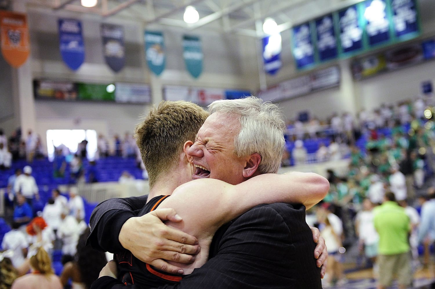 Mercer head coach Bob Hoffman, right, hugs player Jakob Gollon after their win in the Atlantic Sun title game.