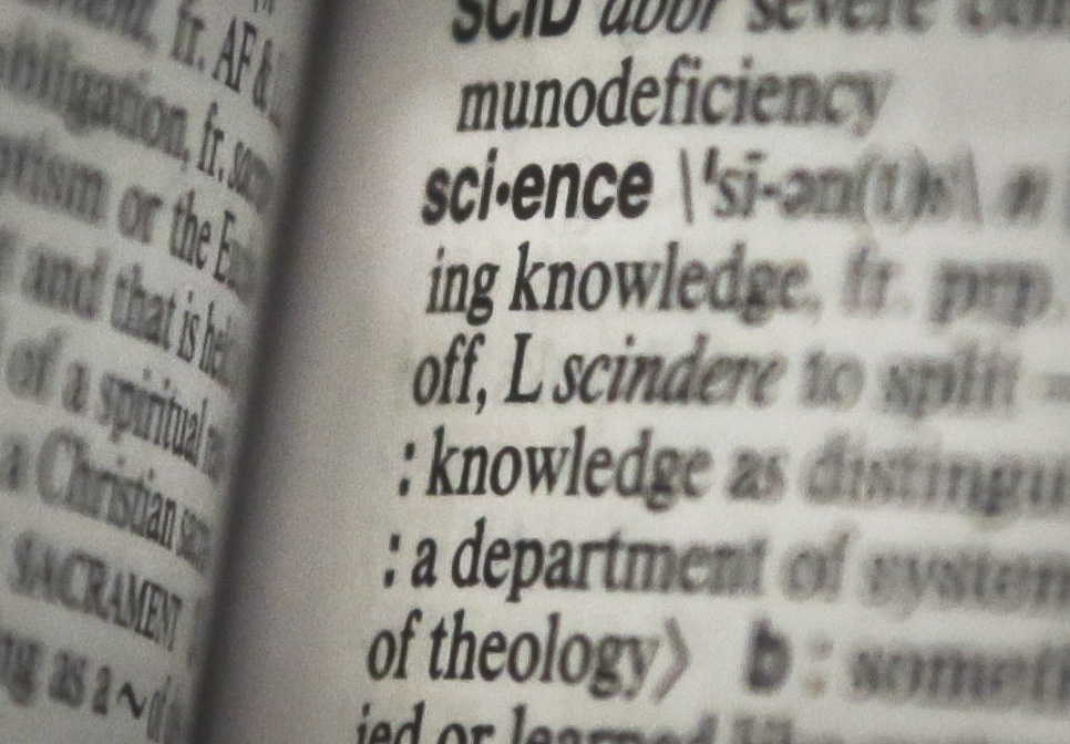 The word &quot;science&quot; on a page of a Merriam-Webster dictionary, in New York.
