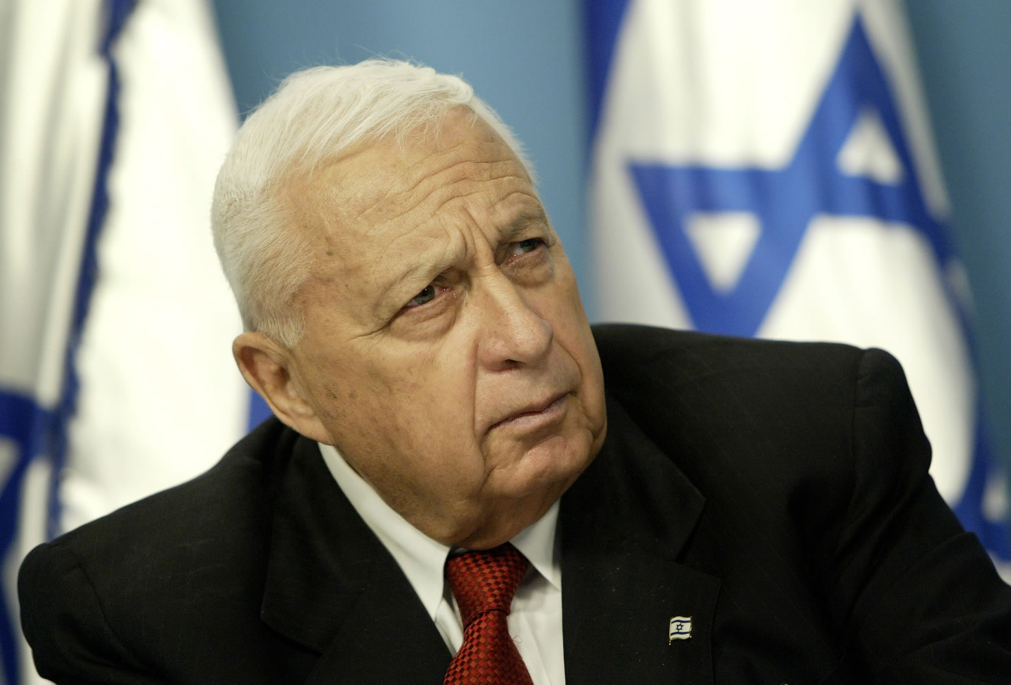 Then Israeli Prime Minister Ariel Sharon pauses during a news conference in his Jerusalem office regarding education reform on May 16, 2004.