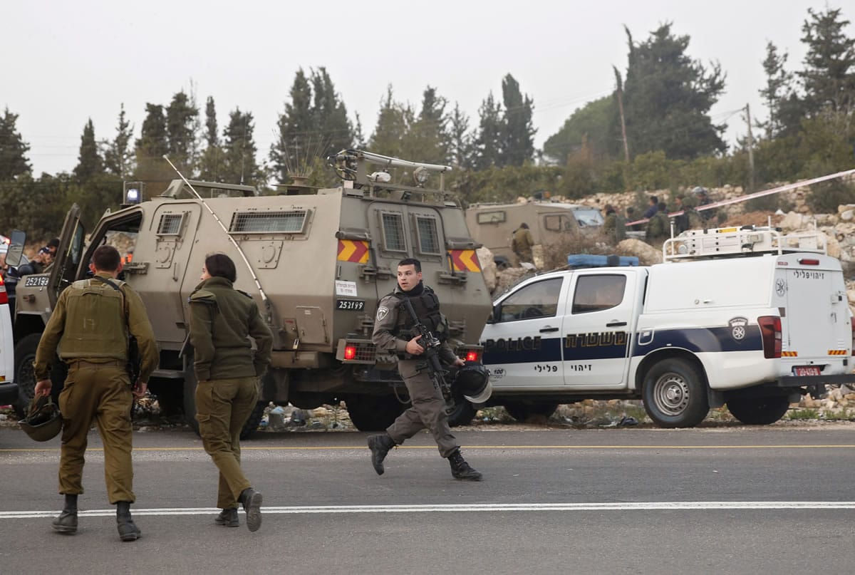 Israeli soldiers stand guard at the Halhul junction, north of the West Bank city of Hebron, Wednesday, Nov. 4, 2015. A Palestinian rammed his vehicle into an Israeli police officer in the West Bank on Wednesday, seriously injuring him before he was shot and killed, police said. It was the latest in a nearly two-month rash of violence that has seen almost daily Palestinian attacks on Israeli civilians and soldiers. In seven weeks, 11 Israelis have been killed, mostly in stabbing attacks, while 70 Palestinians have died by Israeli fire, including 44 who Israel says were involved in attacks or attempted attacks.