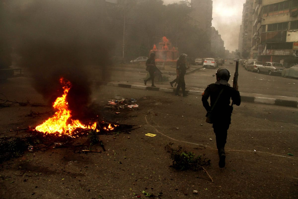 Egyptian riot police move to disperse a protest against a new law regulating demonstrations in Cairo, Egypt, Friday, Nov. 29, 2013.