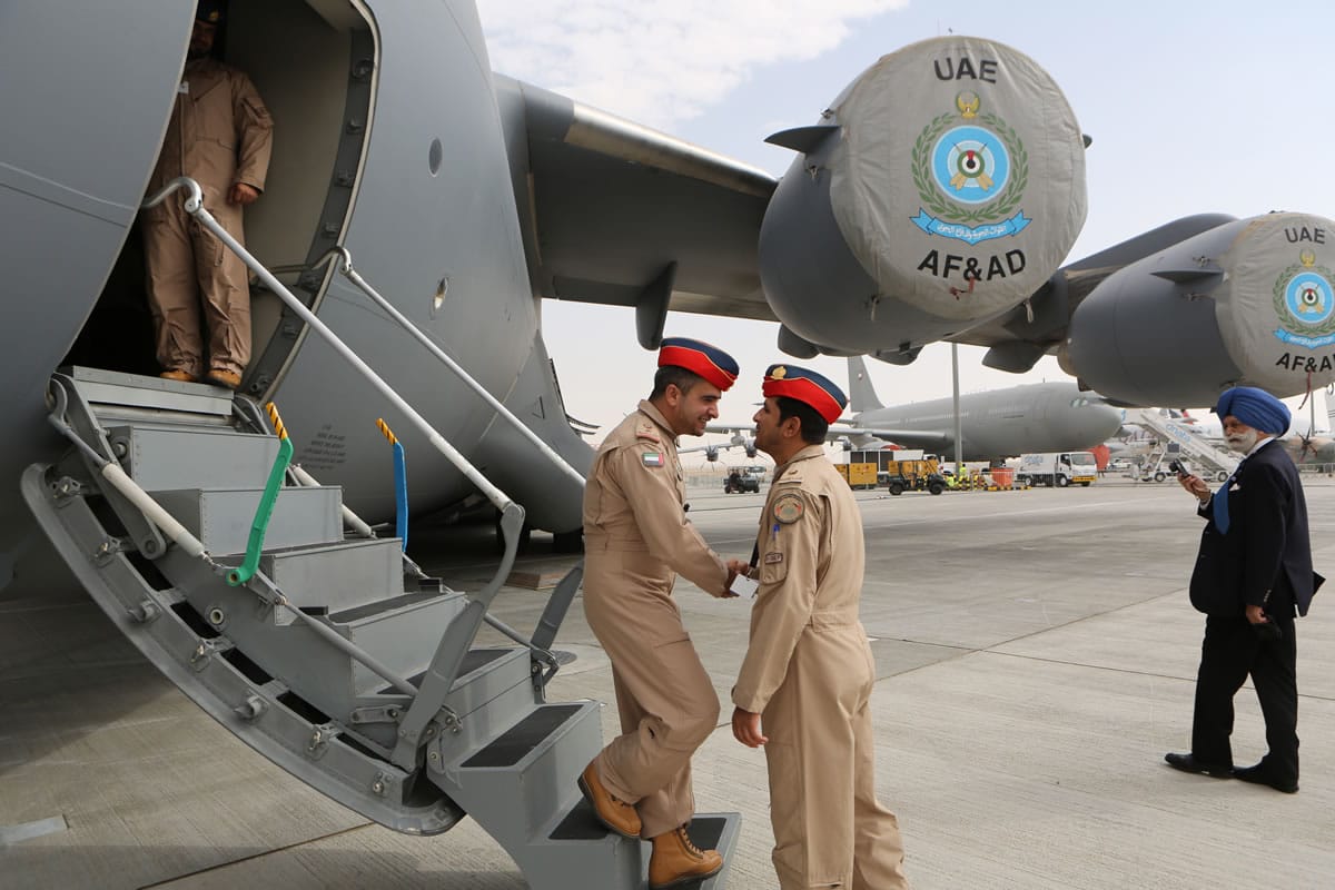 United Arab Emirates pilots greet each other at the steps of a Boeing C-17 Globemaster III, a large military transport aircraft of the UAE Air forces during the opening day of the Dubai Airshow in Dubai, United Arab Emirates, on Sunday.