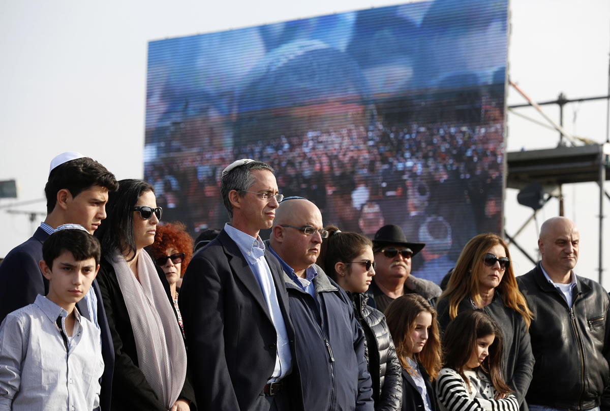 The sons of former Israeli Prime Minister Ariel Sharon, Gilad, fourth left, and Omri, fifth left, attend their father's funeral near Sycamore Farm, Sharon's residence in southern Israel on Monday.