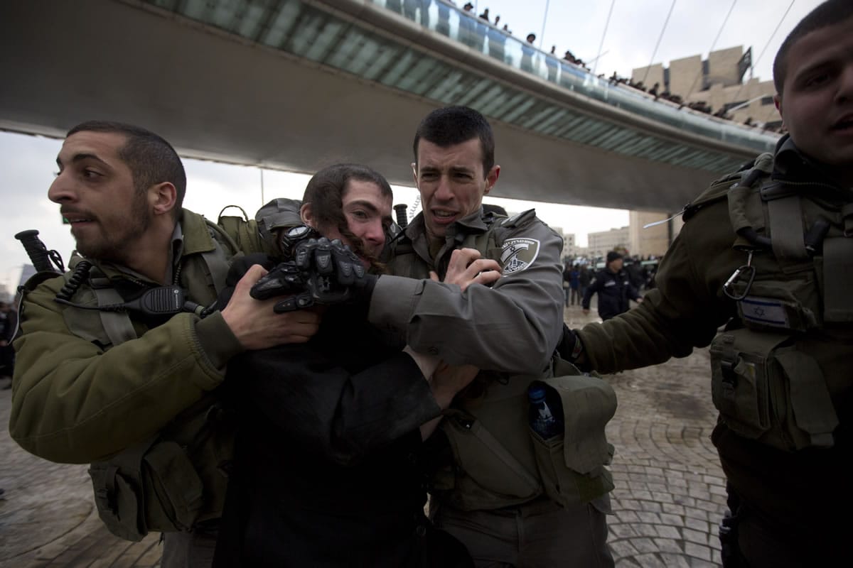 Israeli border police officers detain an ultra-Orthodox Jewish man during a demonstration  Thursday in Jerusalem.