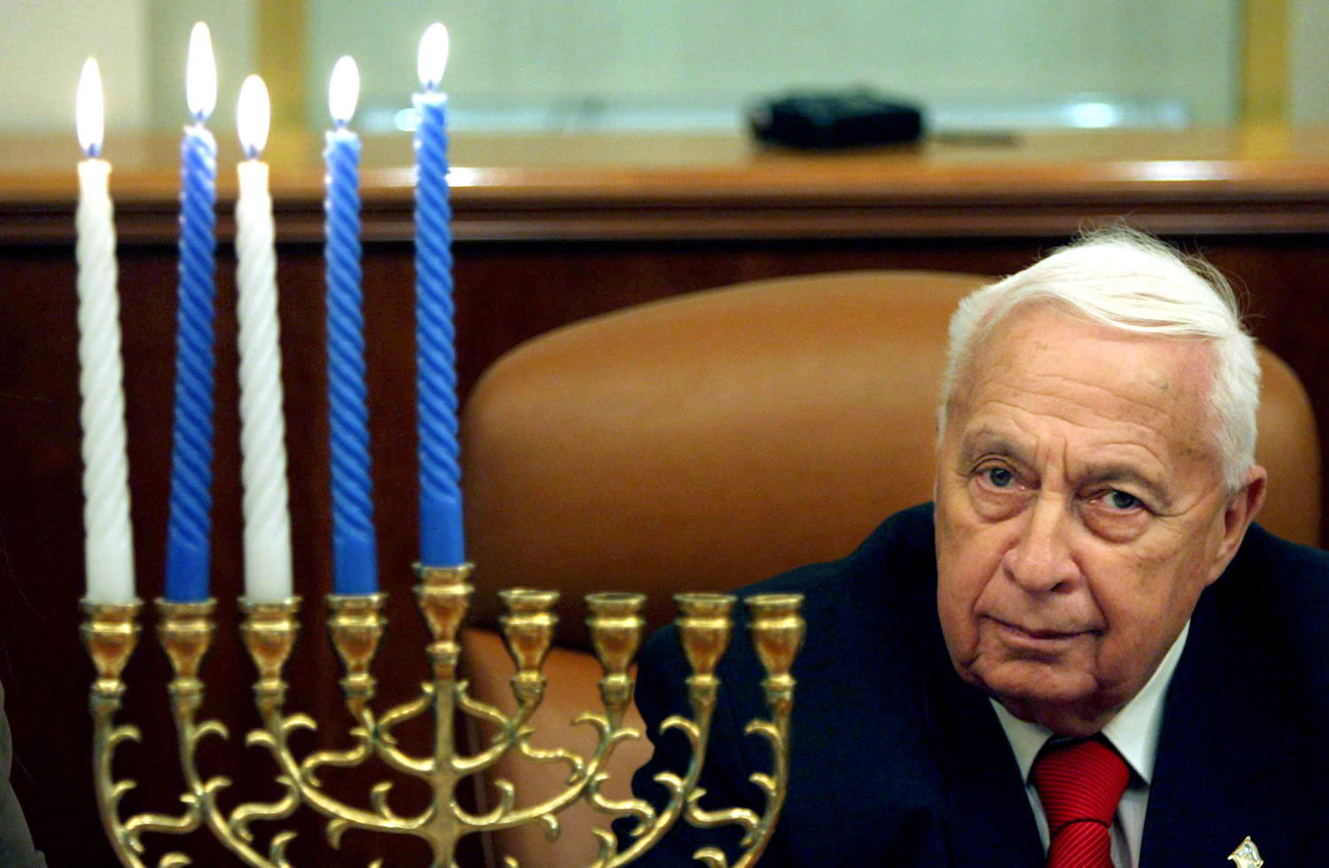 Israeli Prime Minister Ariel Sharon takes part in the lighting of the fourth Hanukkah candle, at his Jerusalem office Dec. 27, 2005. Sharon, the hard-charging Israeli general and prime minister who was admired and hated for his battlefield exploits and ambitions to reshape the Middle East, died Saturday.
