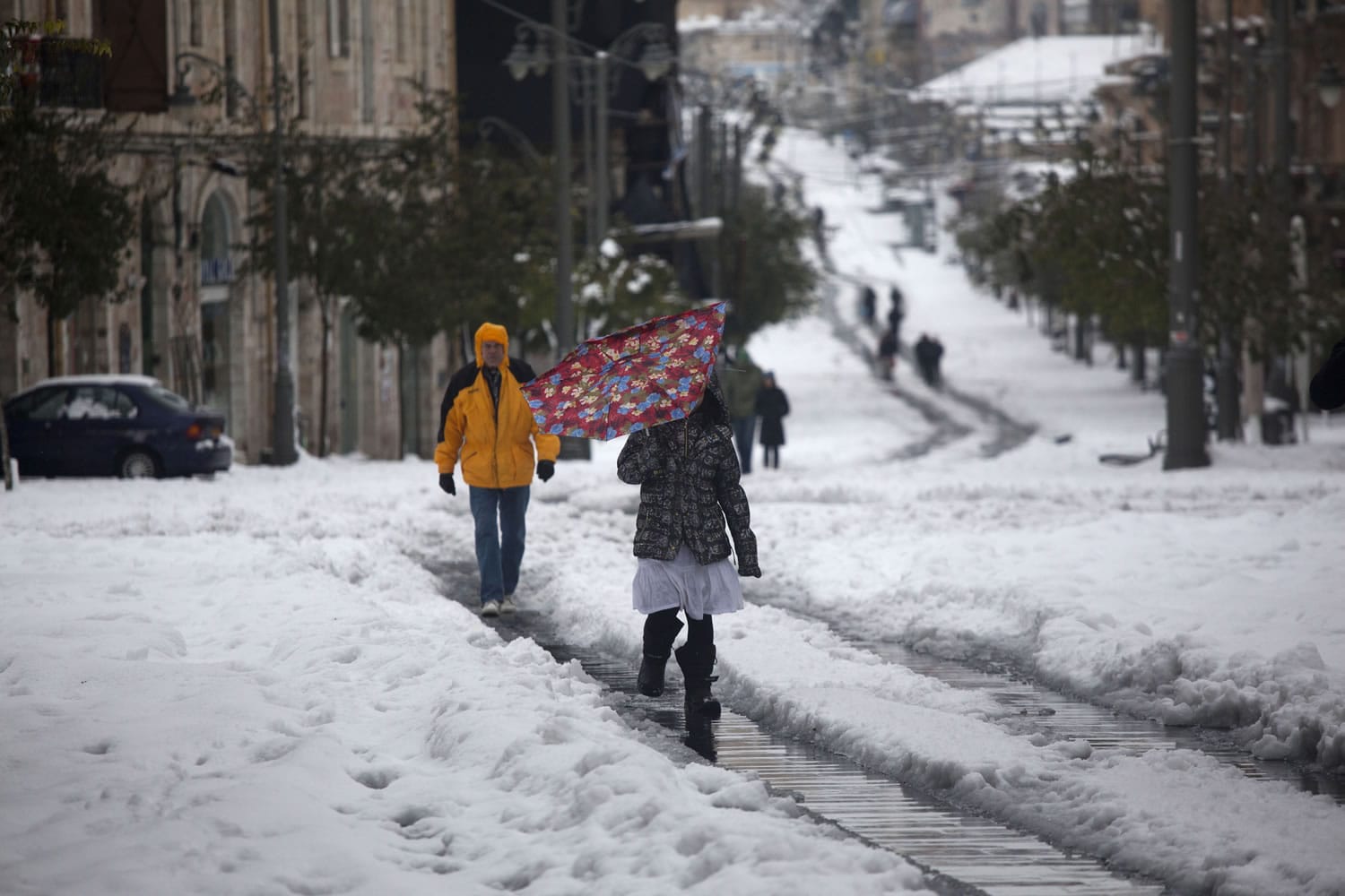 People walk through snow-covered central Jerusalem on Saturday.