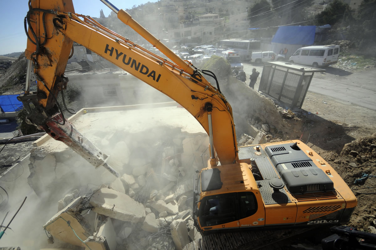 A bulldozer works on a Palestinian home demolished in East Jerusalem on Wednesday.