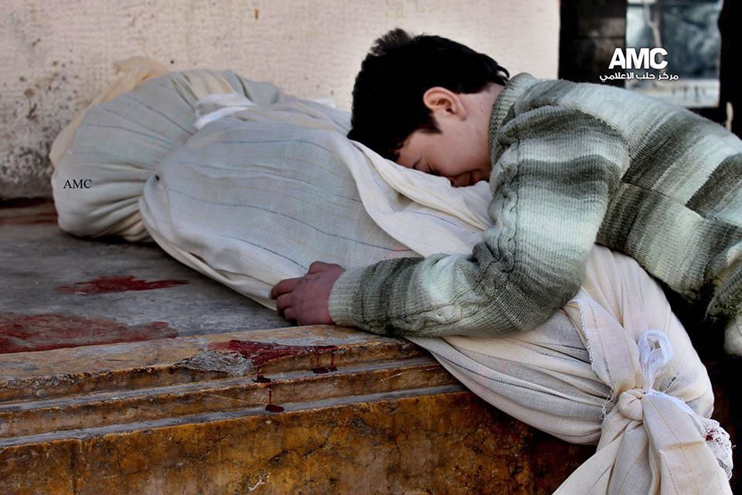 Aleppo Media Center
In this citizen journalism image, a Syrian boy weeps over the shrouded body of his mother after a Syrian government airstrike Friday in Aleppo, Syria.
