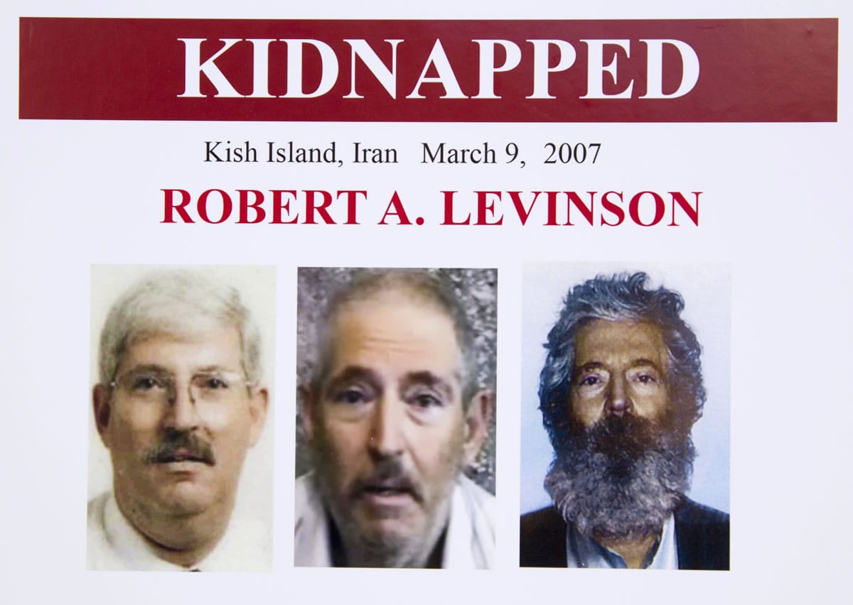 An FBI poster showing a composite image of retired FBI agent Robert Levinson, right, of how he would look like now after five years in captivity, and an image, center, taken from the video, released by his kidnappers, and a picture before he was kidnapped, left, displayed during a news conference in Washington, on March 6, 2012. The FBI announced a reward of up to $1,000,000 for information leading to the safe location, recovery and return of  Levinson, who disappeared from Kish Island, Iran, five years ago on March 9, 2007. For years the U.S. has publicly described him as a private citizen who was traveling on private business. However, an Associated Press investigation reveals that Levinson was working for the CIA.